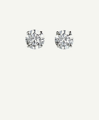 Pair of Jaguarlily Icon round diamond-look stud earrings in silver-tone four-prong settings on an ivory background.
