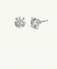 Pair of silver-tone Icon round stud earrings, one facing forward and one angled to show the four-prong setting and bare post, on an ivory background.